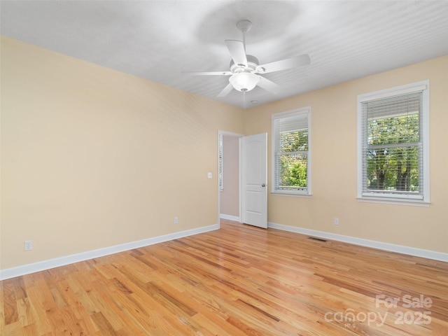 spare room with ceiling fan and light wood-type flooring