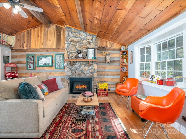 living room featuring wood walls, vaulted ceiling with beams, a fireplace, wooden ceiling, and hardwood / wood-style flooring