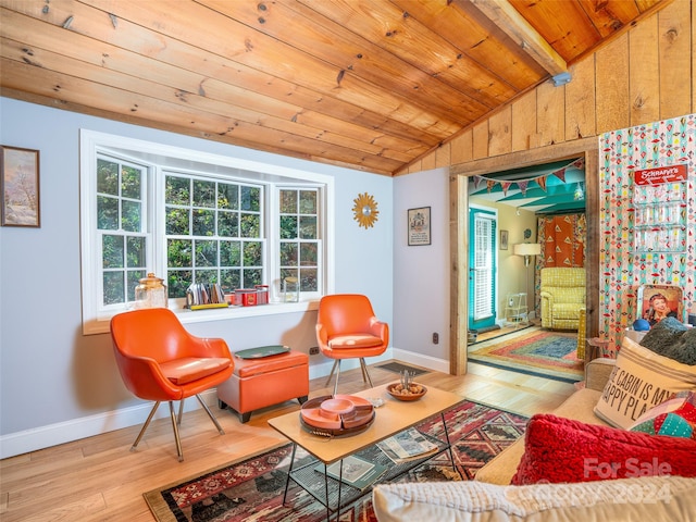 sitting room with hardwood / wood-style flooring, wooden ceiling, vaulted ceiling with beams, and wood walls