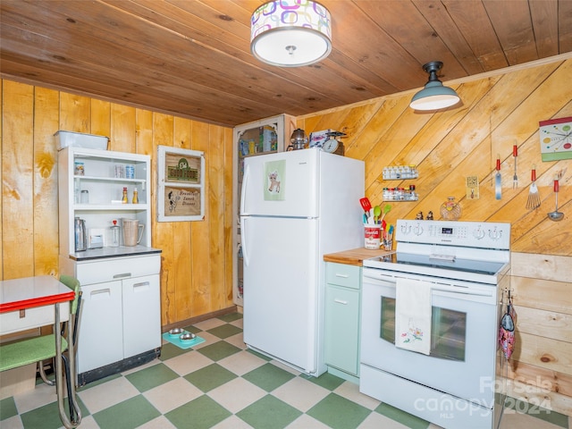 kitchen with white appliances, wood walls, wooden ceiling, and white cabinets