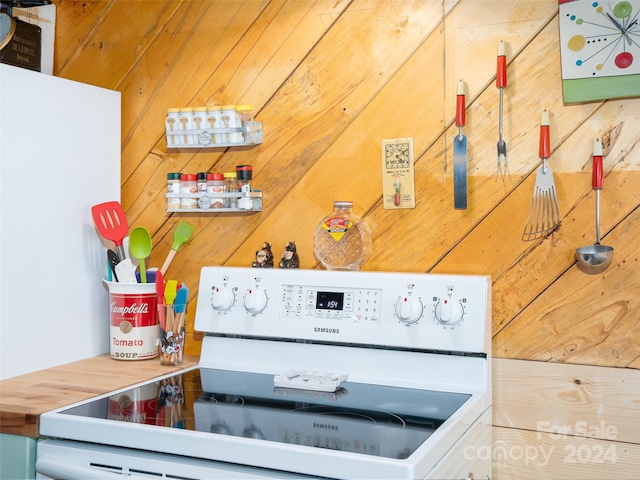 interior space with wooden walls and white stove