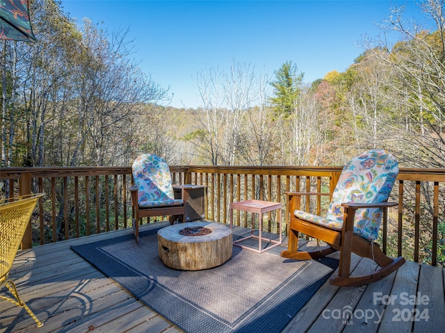 wooden terrace featuring a fire pit