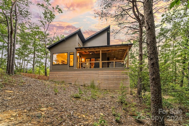 back house at dusk with ceiling fan