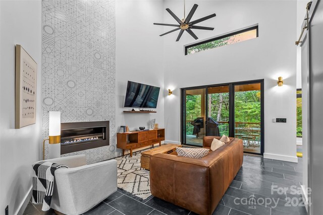 tiled living room with a towering ceiling and ceiling fan