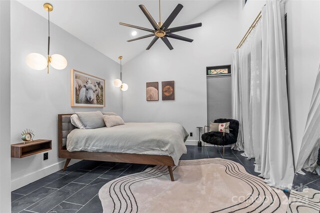 tiled bedroom with ceiling fan and high vaulted ceiling