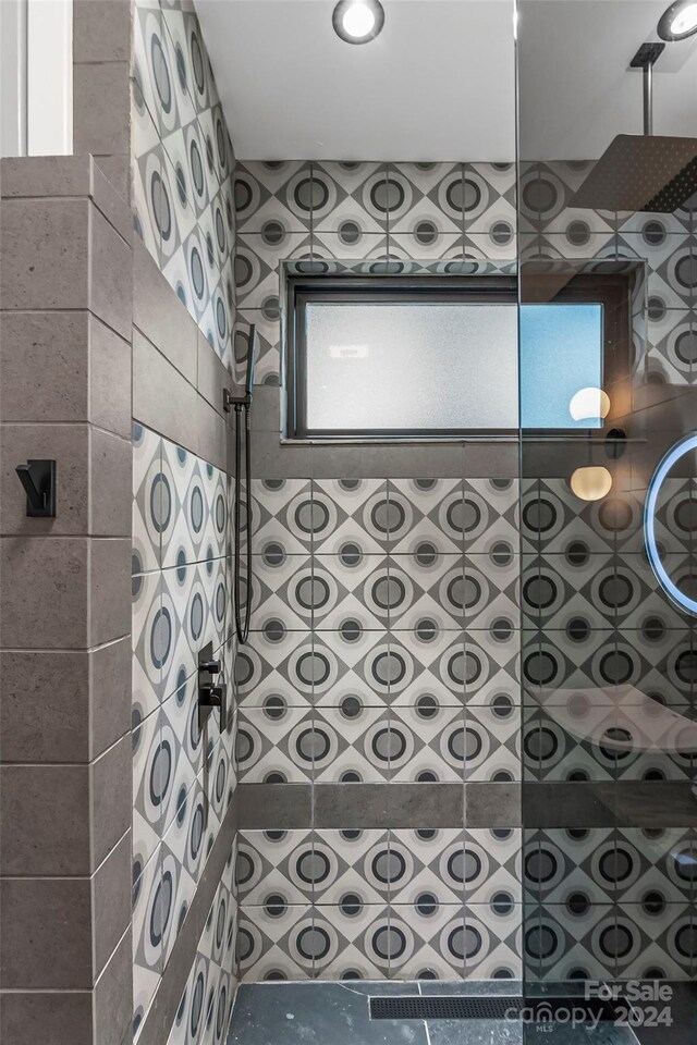 bathroom with a tile shower