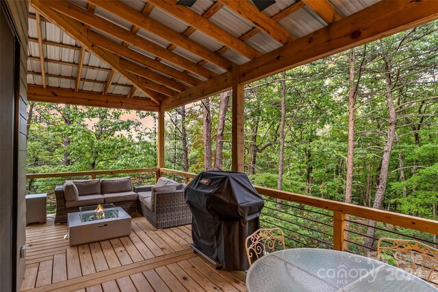 wooden deck featuring an outdoor hangout area and a grill