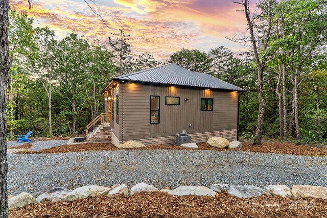 property exterior at dusk featuring central AC unit