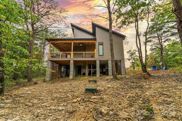 view of back house at dusk