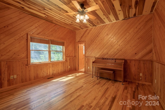 bonus room with wood walls and light hardwood / wood-style floors