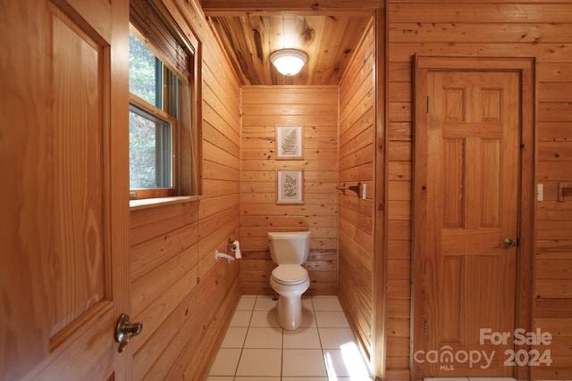 bathroom with wooden walls, tile patterned flooring, toilet, and wood ceiling