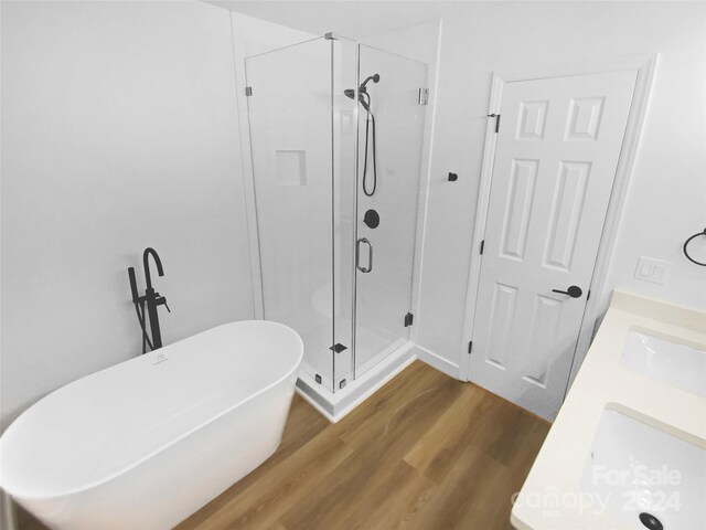 bathroom featuring vanity, hardwood / wood-style floors, and separate shower and tub