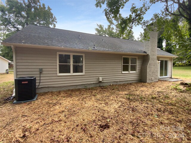 back of property featuring central air condition unit