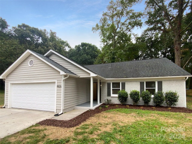 ranch-style house with a front lawn and a garage