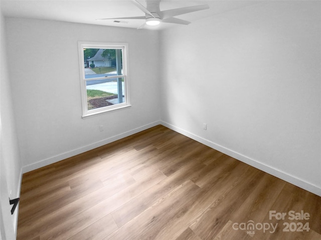 unfurnished room with ceiling fan and wood-type flooring