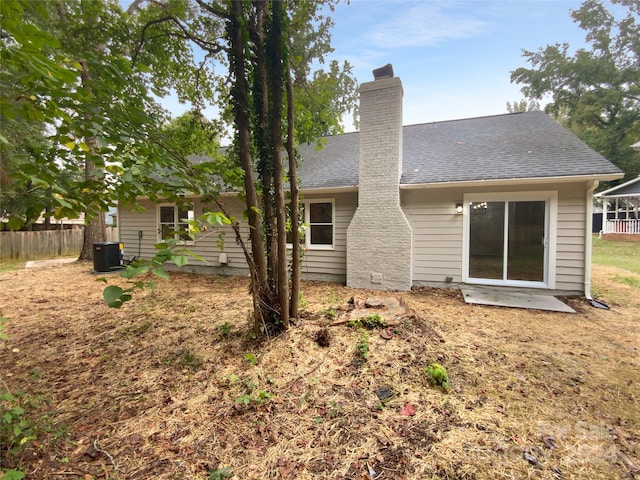 back of house featuring cooling unit