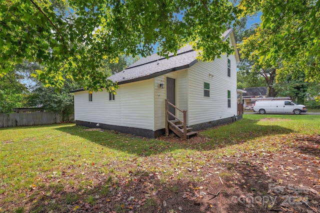 back of property featuring a yard