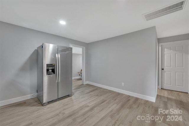 kitchen featuring stainless steel refrigerator with ice dispenser and light hardwood / wood-style flooring