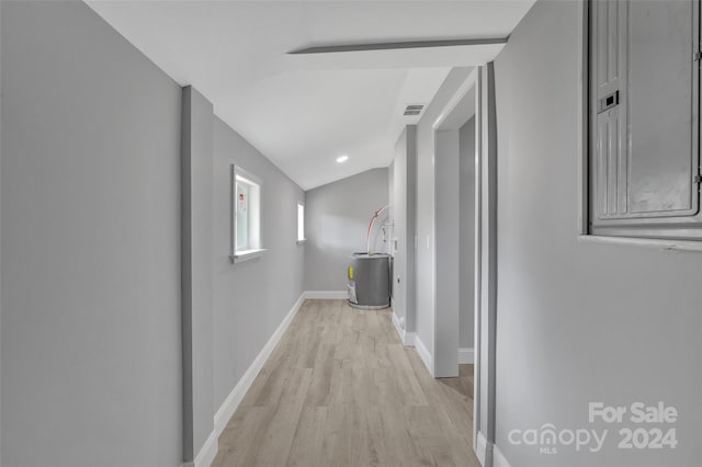 hallway featuring light hardwood / wood-style floors and vaulted ceiling