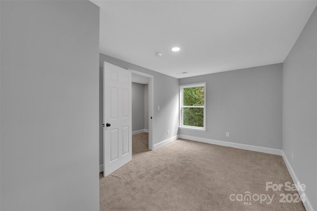 empty room with light colored carpet