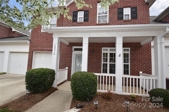 view of front of home with a garage and a porch