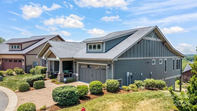 craftsman inspired home with a front yard and a garage