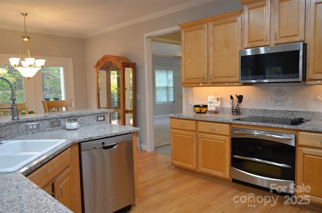 kitchen featuring appliances with stainless steel finishes, light brown cabinets, pendant lighting, light hardwood / wood-style flooring, and a chandelier