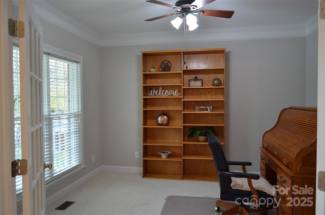 home office with light colored carpet, ceiling fan, and ornamental molding