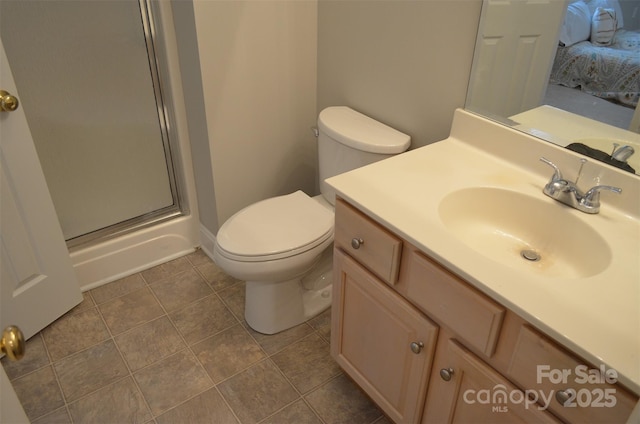 bathroom with toilet, vanity, and walk in shower