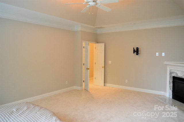 interior space with ceiling fan, a fireplace, carpet, and ornamental molding