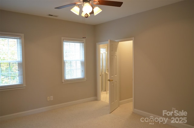 unfurnished bedroom featuring ceiling fan and light carpet