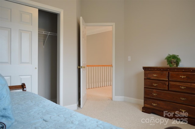 bedroom featuring light carpet and a closet