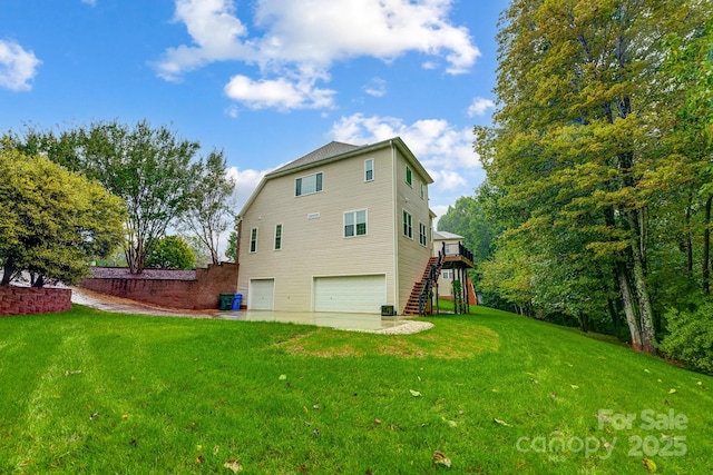 rear view of property featuring a lawn and a garage