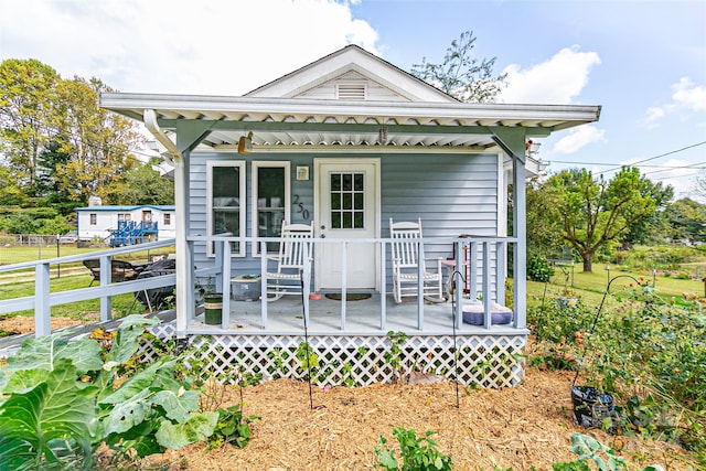 rear view of property featuring a deck