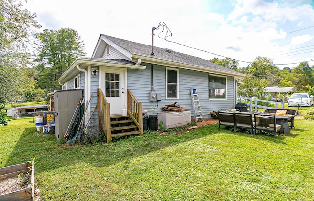 rear view of property featuring a yard