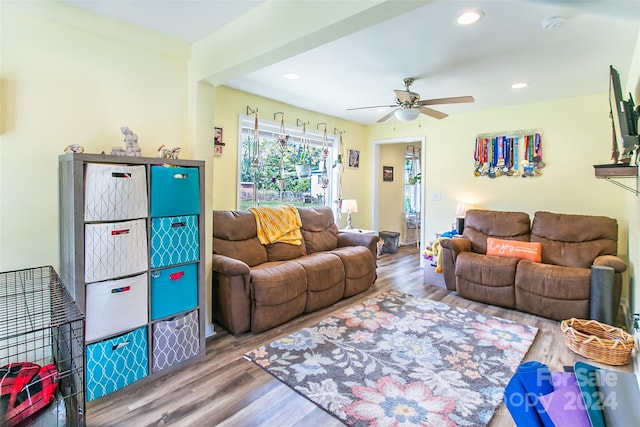 living room featuring ceiling fan and hardwood / wood-style floors