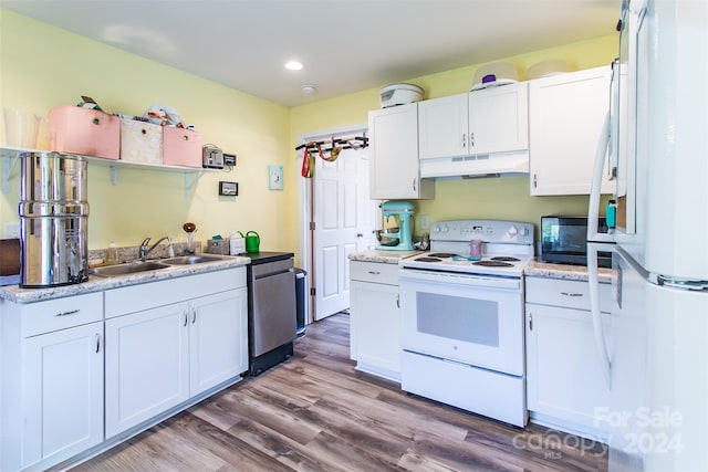 kitchen featuring white appliances, sink, and white cabinets