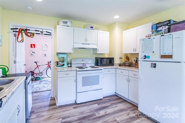 kitchen featuring white appliances, white cabinetry, and light hardwood / wood-style flooring