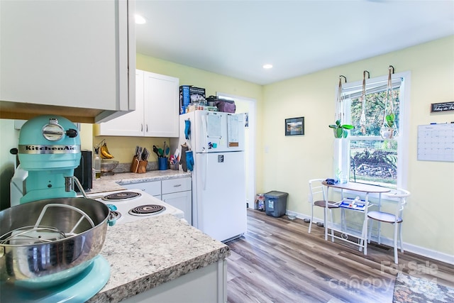 kitchen featuring white refrigerator, white cabinetry, and light hardwood / wood-style flooring