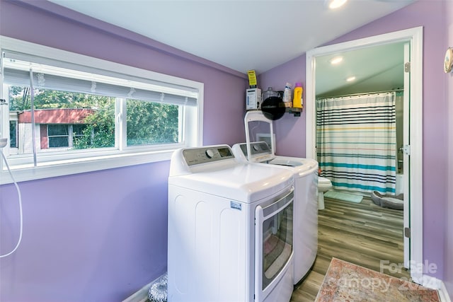 washroom featuring washing machine and dryer and hardwood / wood-style flooring