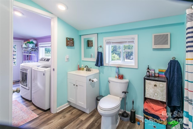 bathroom with toilet, hardwood / wood-style floors, separate washer and dryer, lofted ceiling, and vanity