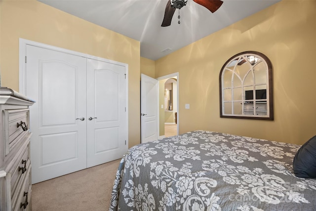 carpeted bedroom with a closet and ceiling fan