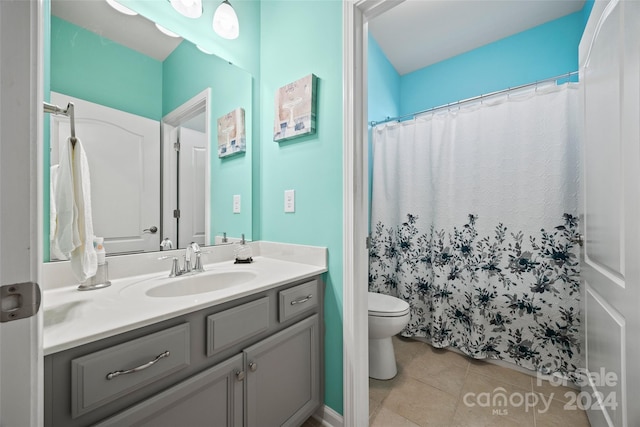 bathroom with vanity, a shower with shower curtain, toilet, and tile patterned floors