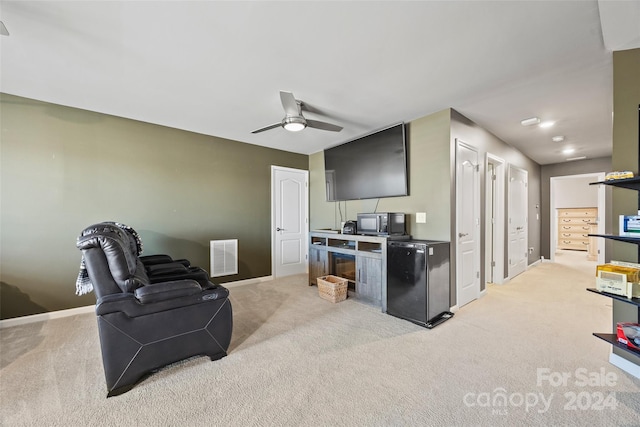 carpeted living room with ceiling fan