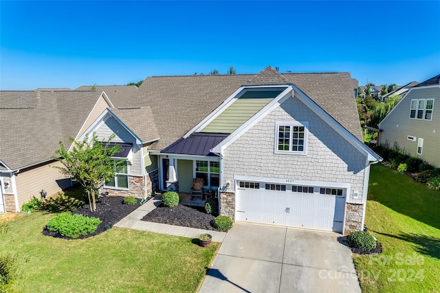 craftsman-style home featuring a front lawn and a garage