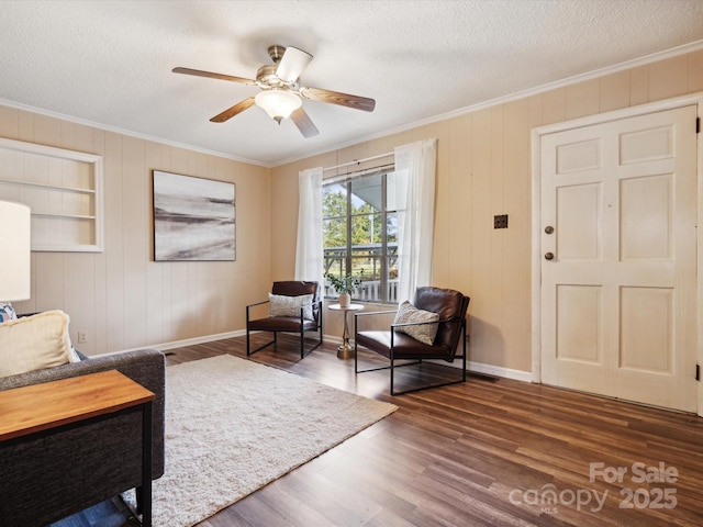 living area featuring dark hardwood / wood-style flooring, ceiling fan, built in features, and a textured ceiling