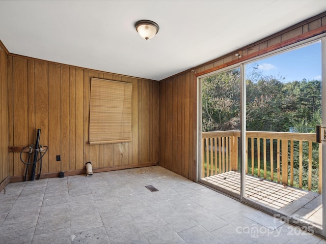 empty room featuring wooden walls