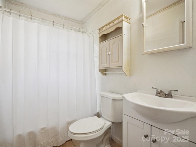 bathroom featuring crown molding, vanity, and toilet