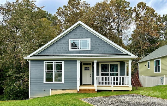 view of front of property with a front yard and a porch