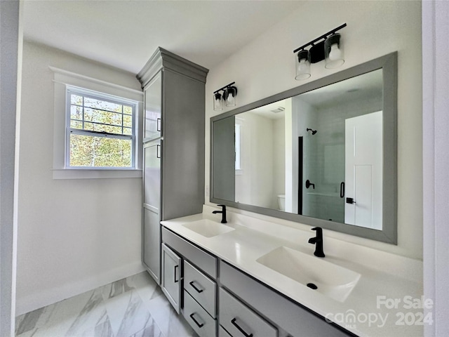 bathroom with vanity, toilet, and an enclosed shower